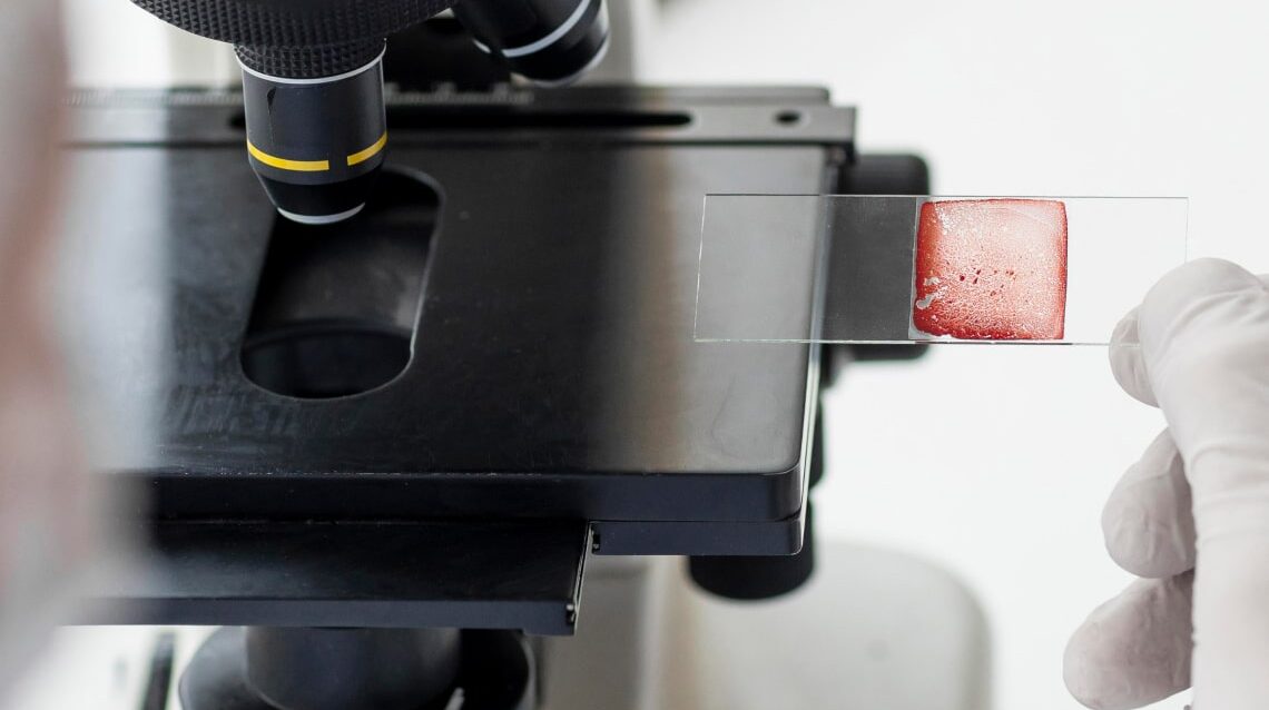 close-up-scientist-with-microscope-1-min